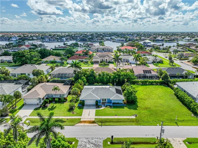 Aerial perspective of suburban area featuring a nearby body of water
