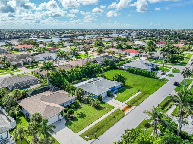 Aerial perspective of suburban area featuring a large body of water