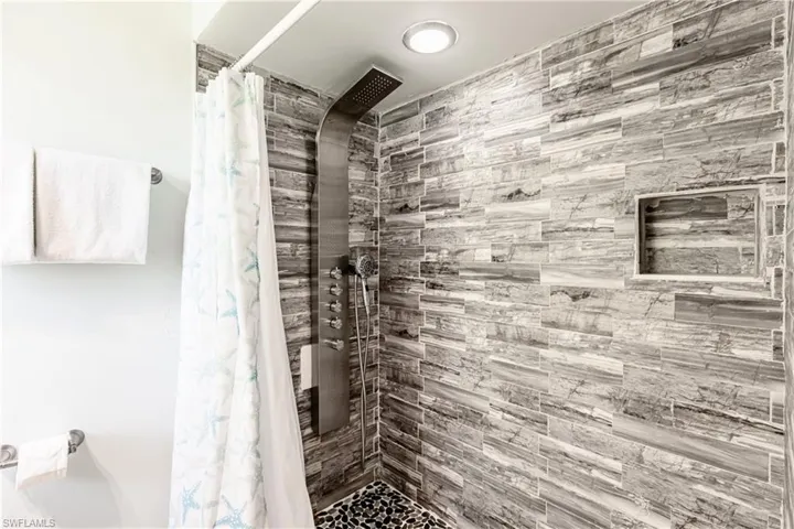 Full bath with a tile shower