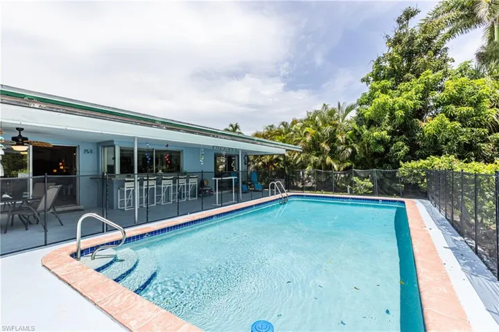View of pool with a patio area and a ceiling fan