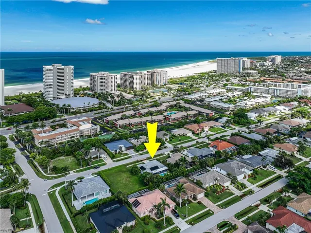 Aerial view of property and surrounding area featuring a large body of water and nearby urban area