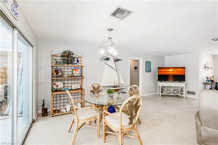Dining space featuring speckle patterned floor and baseboards