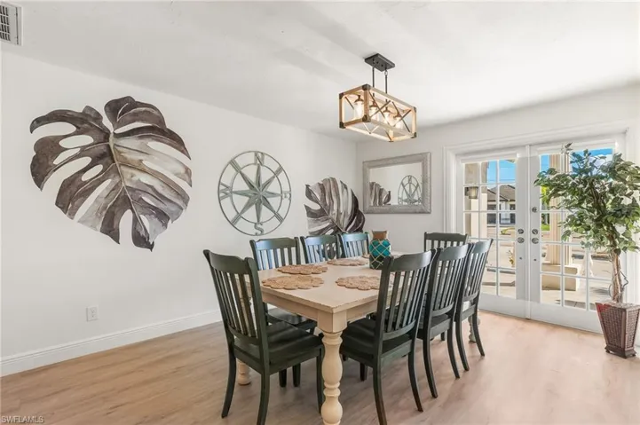 Dining room with french doors and light wood-type flooring