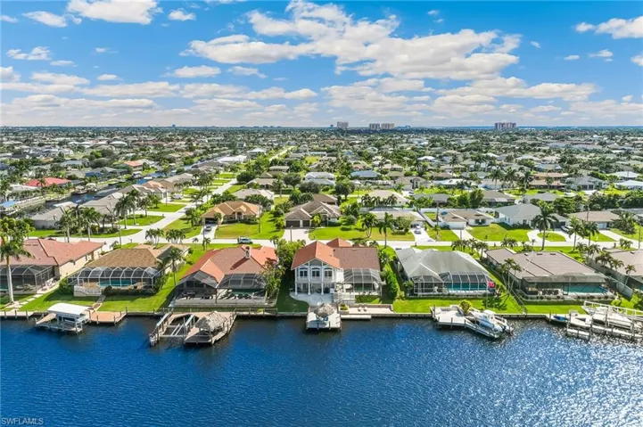 Aerial perspective of suburban area featuring a large body of water
