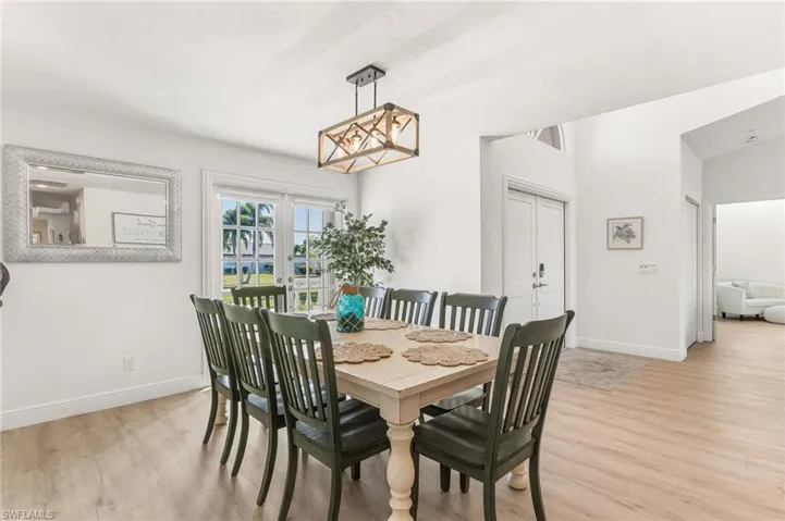 Dining room featuring light wood-type flooring and french doors
