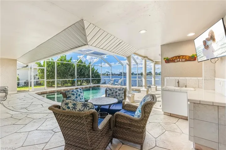 View of patio with a sunroom, a lanai, and an outdoor pool