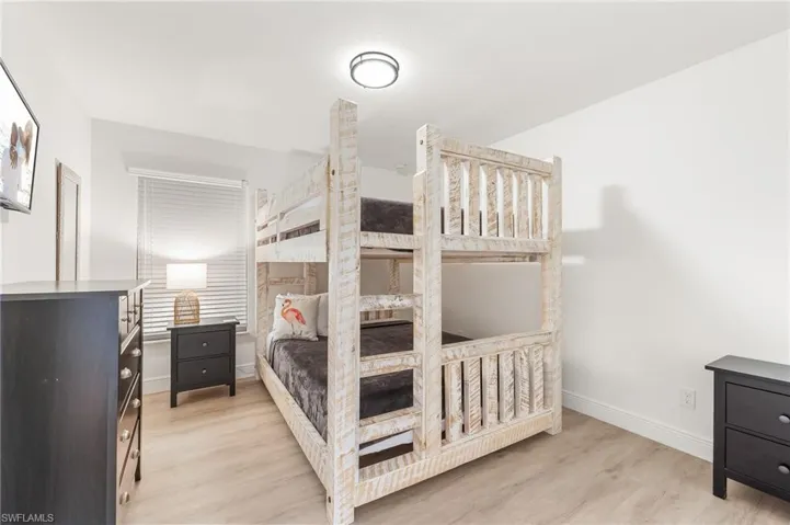 Bedroom with light wood-style flooring and baseboards
