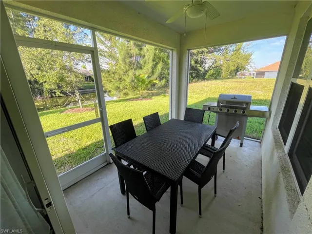 Sunroom / solarium with ceiling fan and outdoor dining area