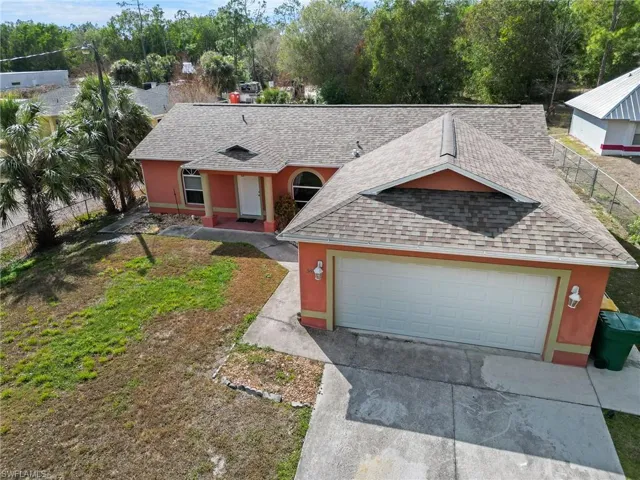 View of front of home featuring a shingled roof, stucco siding, driveway, and an attached garage