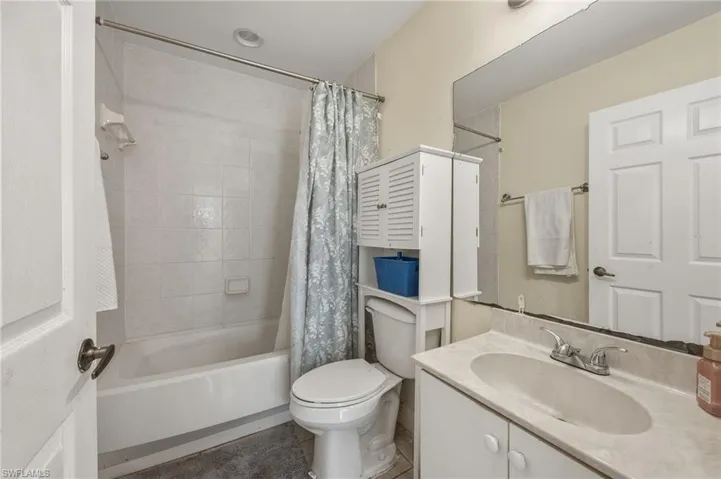 Bathroom with vanity and shower / tub combo with curtain