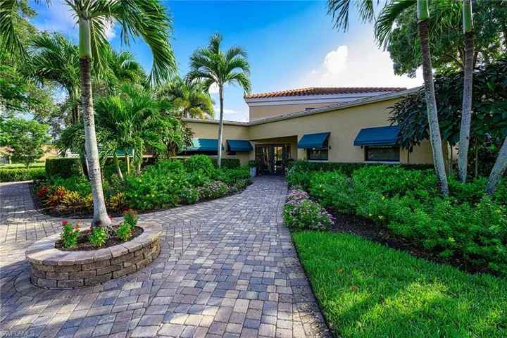 View of front of house featuring french doors, stucco siding, and a tiled roof