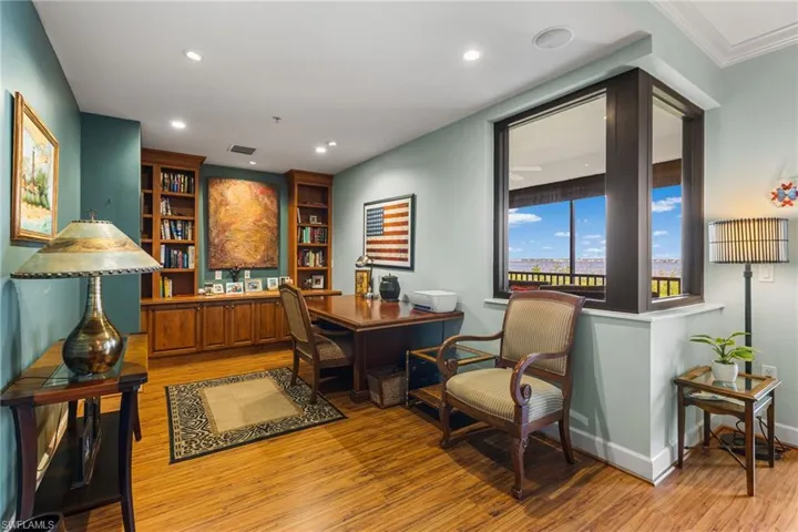 Amazing space in your primary bedroom! Endless possibilities! Built in wood bookcases and cabinetry.