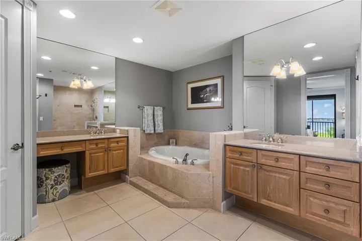 Primary bath has separate granite countertop vanities, soaking tub and a walk in shower.