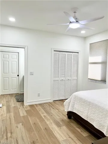Bedroom 3 with ceiling fan and light wood-type flooring