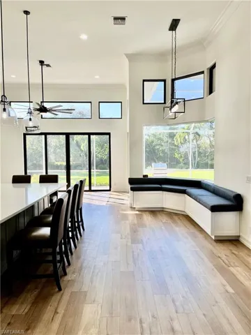 Open Dining space featuring light hardwood / wood-style flooring, a wealth of natural light, and crown molding