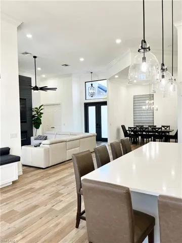 Open Dining space featuring ceiling fan, crown molding, and light hardwood / wood-style floors
