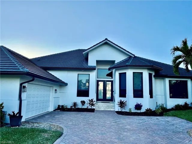 View of front of home  and garage featuring french doors and a garage