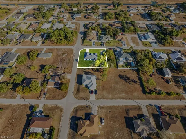 Aerial overview of property's location featuring nearby suburban area and property parcel outlined
