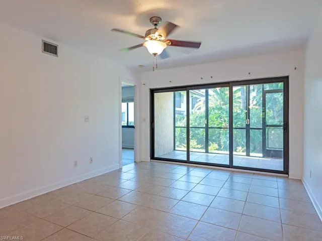 Spare room featuring light tile patterned flooring and a ceiling fan