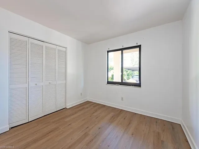 Unfurnished bedroom with light wood finished floors and a closet
