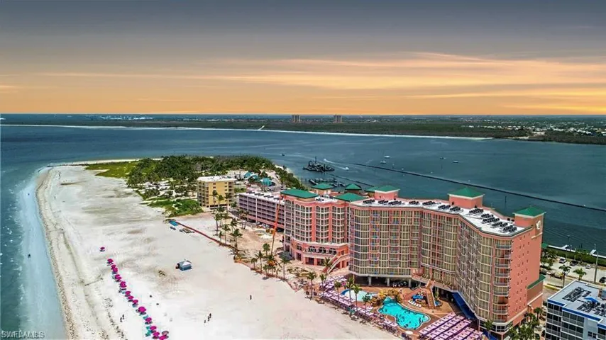 Aerial view at dusk with a view of the beach and a water view