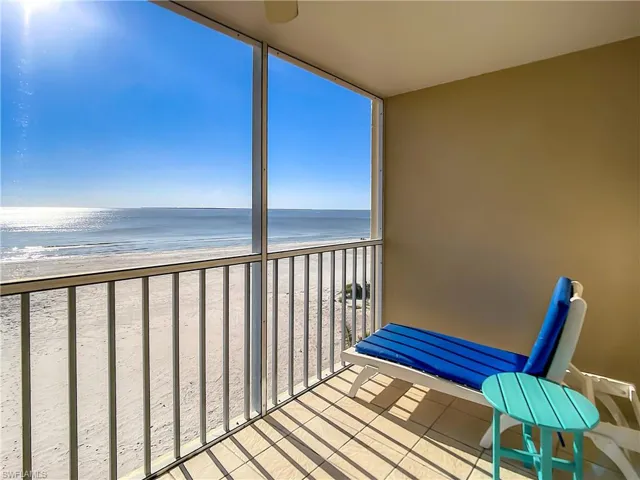Balcony with a water view and a view of the beach