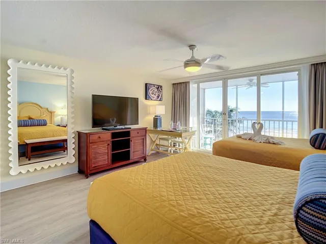 Bedroom featuring access to outside, light hardwood / wood-style flooring, and ceiling fan