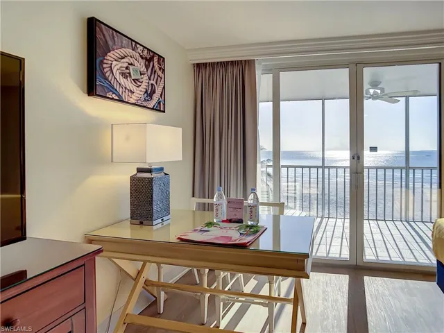 Dining area featuring a water view and ceiling fan