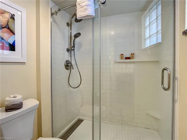 Bathroom featuring an enclosed shower and toilet