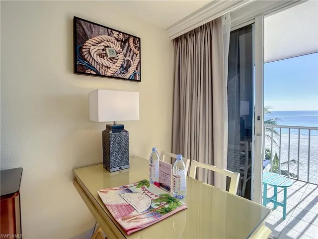 Tiled dining area featuring a water view