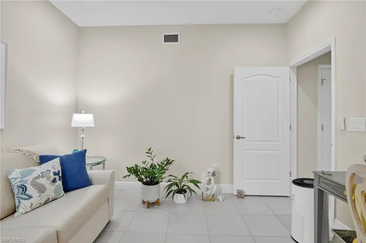 Living area featuring tile patterned flooring and baseboards