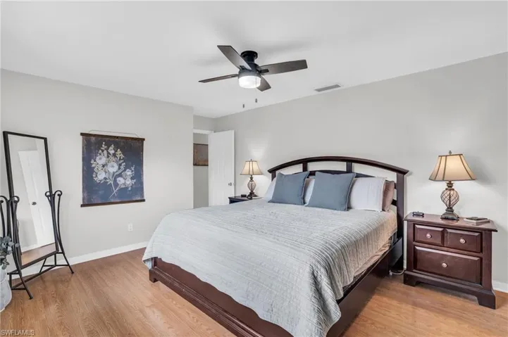 Bedroom with ceiling fan and hardwood / wood-style flooring