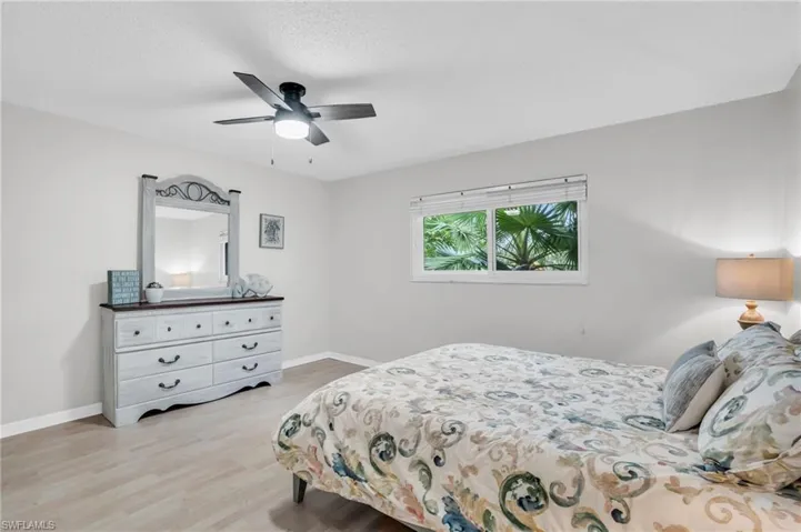 Bedroom with ceiling fan and light hardwood / wood-style floors