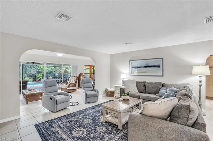 Tiled living room with a textured ceiling