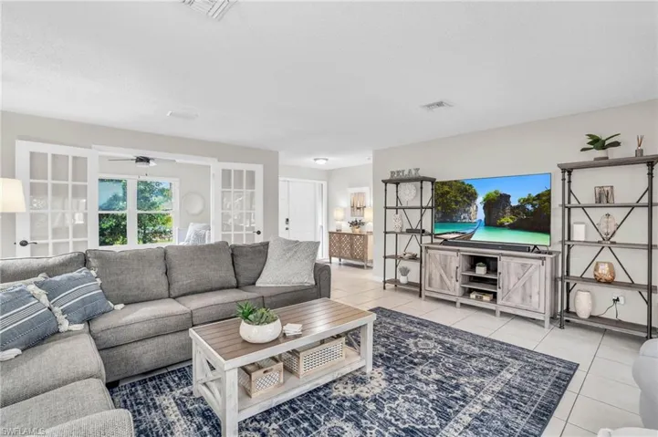 Living room with light tile patterned floors