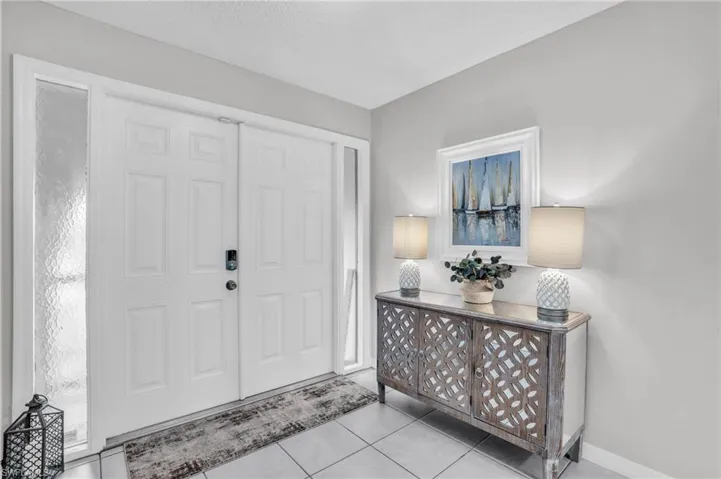 Foyer entrance with light tile patterned floors
