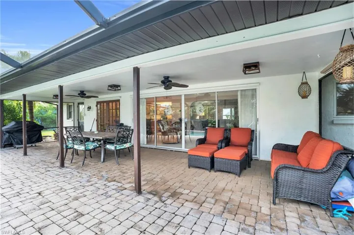 View of patio with grilling area, outdoor lounge area, and ceiling fan