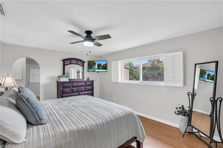 Bedroom featuring ceiling fan and hardwood / wood-style flooring