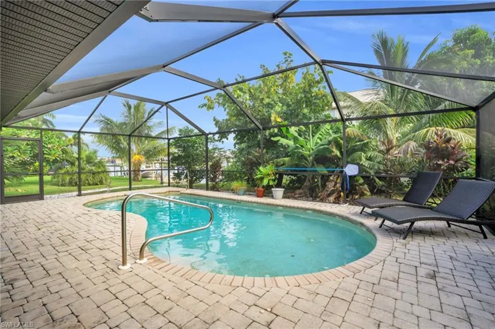 View of pool with a lanai and a patio