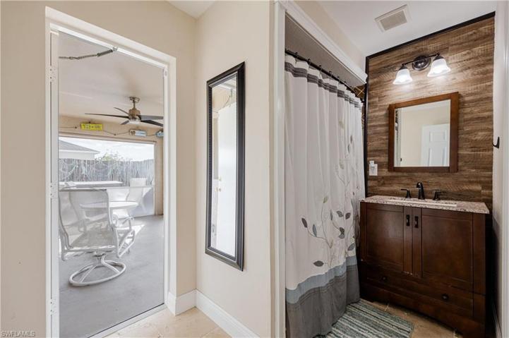 Bathroom has door to the screened back patio/porch