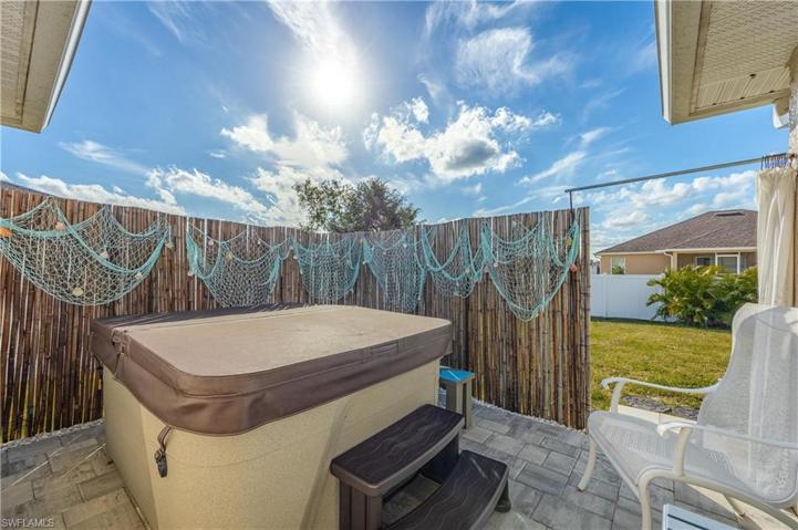 Hot tub with pavers and privacy fence