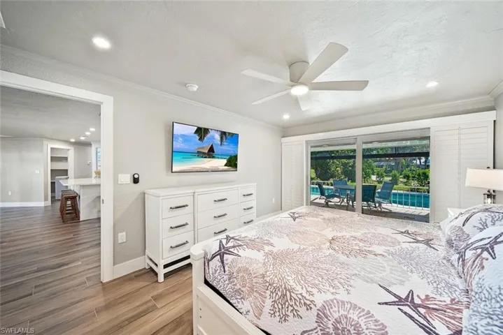 Bedroom featuring ornamental molding, light wood-type flooring, a ceiling fan, access to outside, and recessed lighting