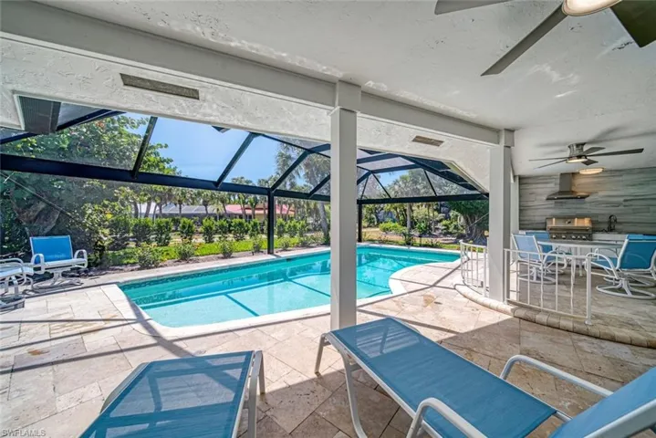 Outdoor pool featuring a patio, a lanai, a sunroom, and outdoor dining area
