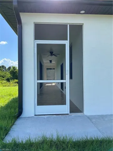 Doorway to property with stucco siding