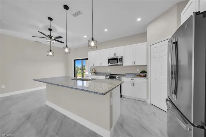 Unfurnished bedroom with a closet, light marble finish flooring, and a ceiling fan