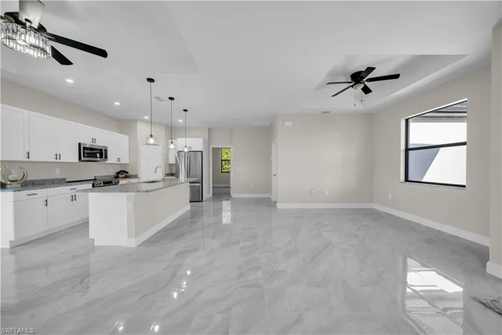 Empty room with ceiling fan and baseboards