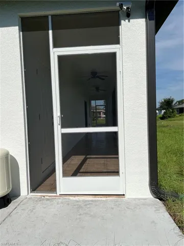 Property entrance featuring stucco siding