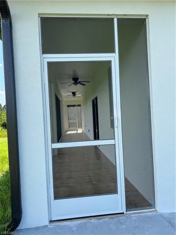 Entrance to property with stucco siding