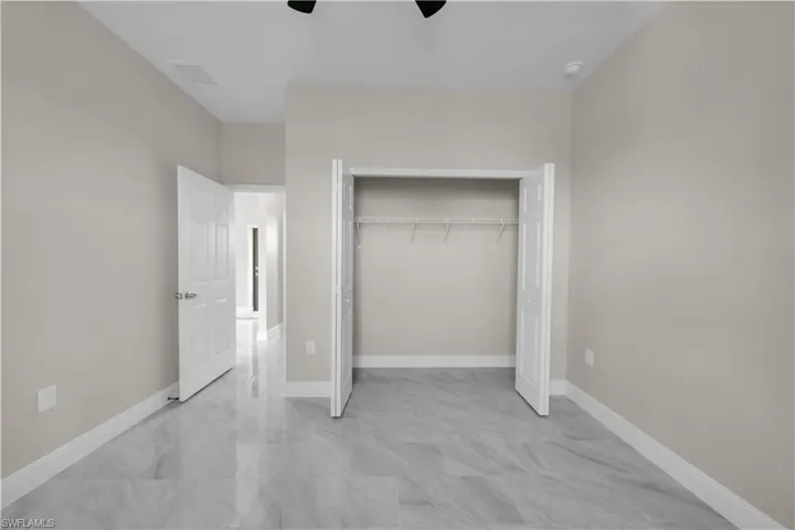 Full bath featuring a marble finish shower, double vanity, marble finish flooring, and recessed lighting