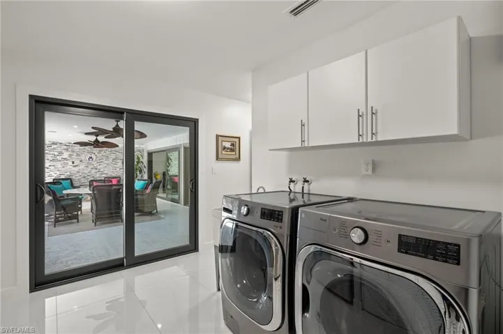 Laundry area with ceiling fan, cabinets, and independent washer and dryer